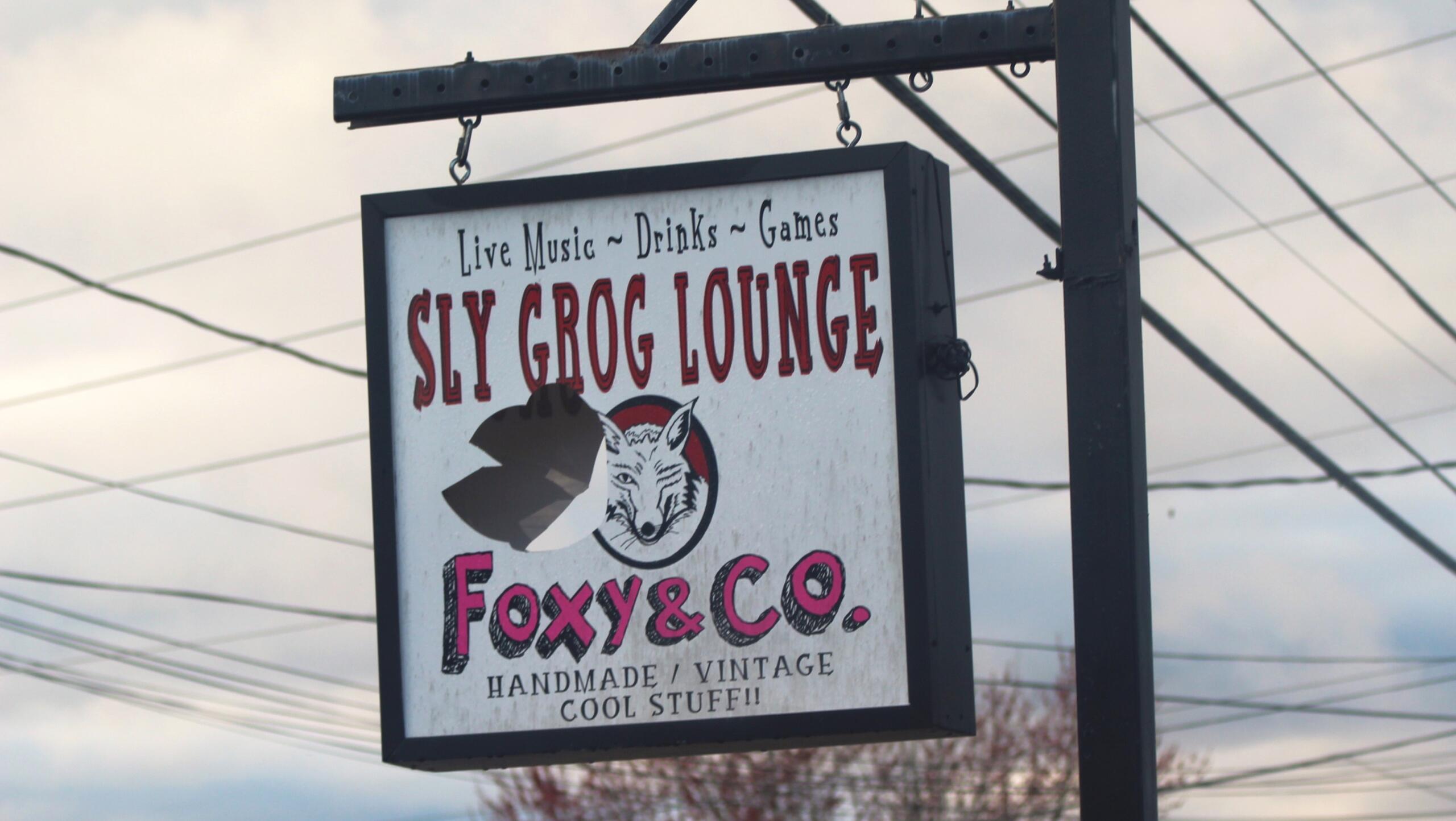 A damaged Sly Grog Lounge sign still hangs outside the fire damaged building as owners prepare for a re-opening on May 17, 2024.
