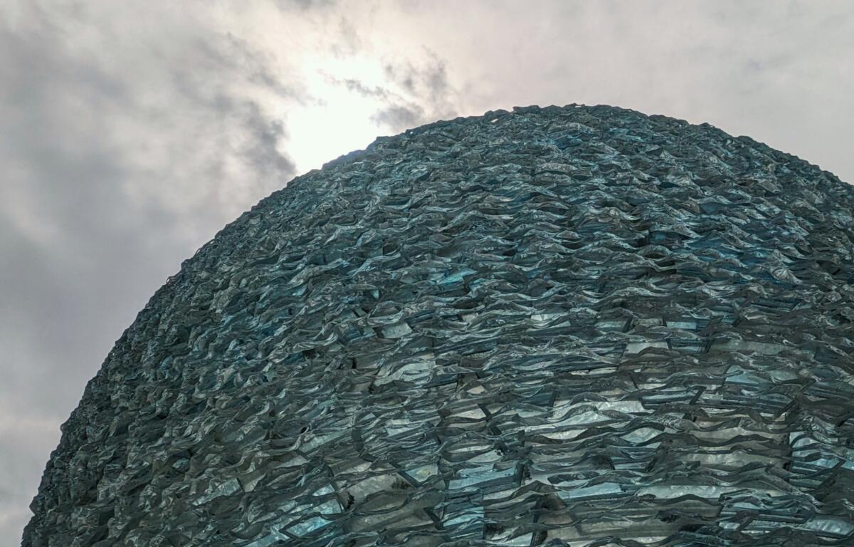 The sculpture "Reflections on Unity" by artist Henry Richardson is seen outside the Asheville Art Museum just prior to a solar eclipse on April 8, 2024.