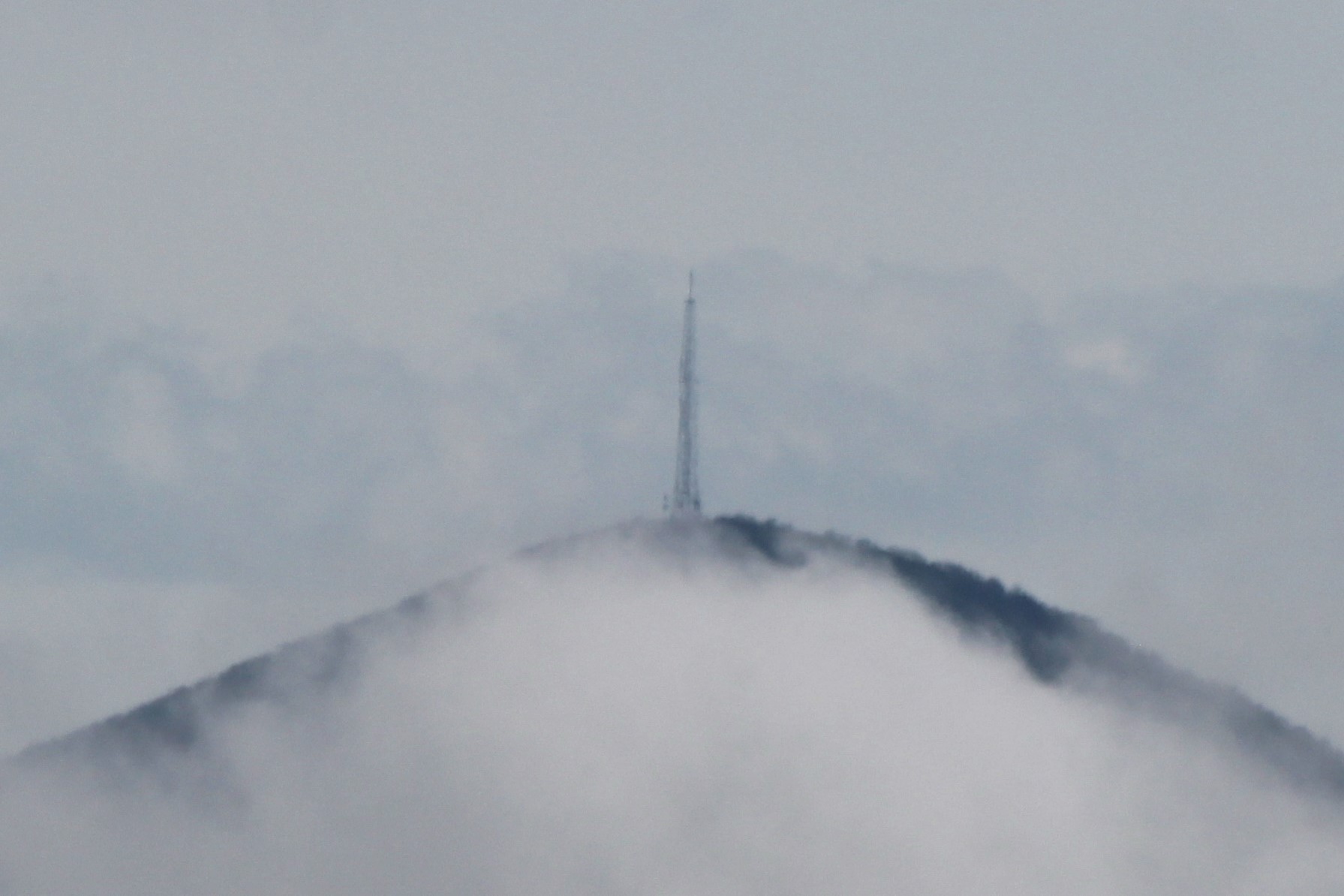 Mount Pisgah appears through the clouds on Saturday, April 20, 2024.