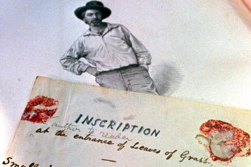 An introduction to Walt Whitman's "Leaves of Grass" lies next to the poet's engraving in the rare first copy of the book at The College of New Jersey library in Ewing, N.J., Wednesday, Nov. 19, 1997. Professor Michael Robertson came across the 130-year-old inscription by Whitman, written in pen and pencil on several small pieces of paper, during a recent examination of the book which was in the library's vault. (AP Photo/Daniel Hulshizer)