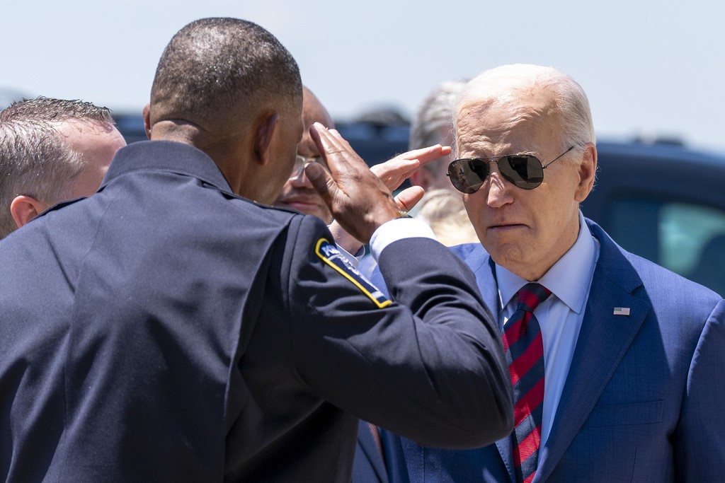 President Joe Biden salutes Charlotte-Mecklenburg Police Department Chief Johnny Jennings, as he arrives on Air Force One at Charlotte Douglas International Airport, Thursday, May 2, 2024, in Charlotte, N.C. Biden is meeting with the families of law enforcement officers shot to death on the job. (AP Photo/Alex Brandon)