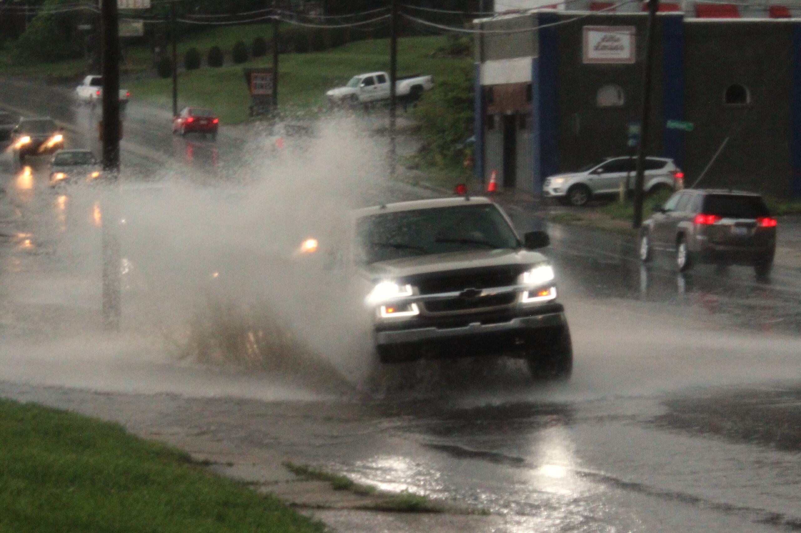 Waves of rain left some minor street flooding at low points in roadways, as on Smokey Park Highway, on Saturday afternoon, May 4, 2024, in West Asheville, N.C.