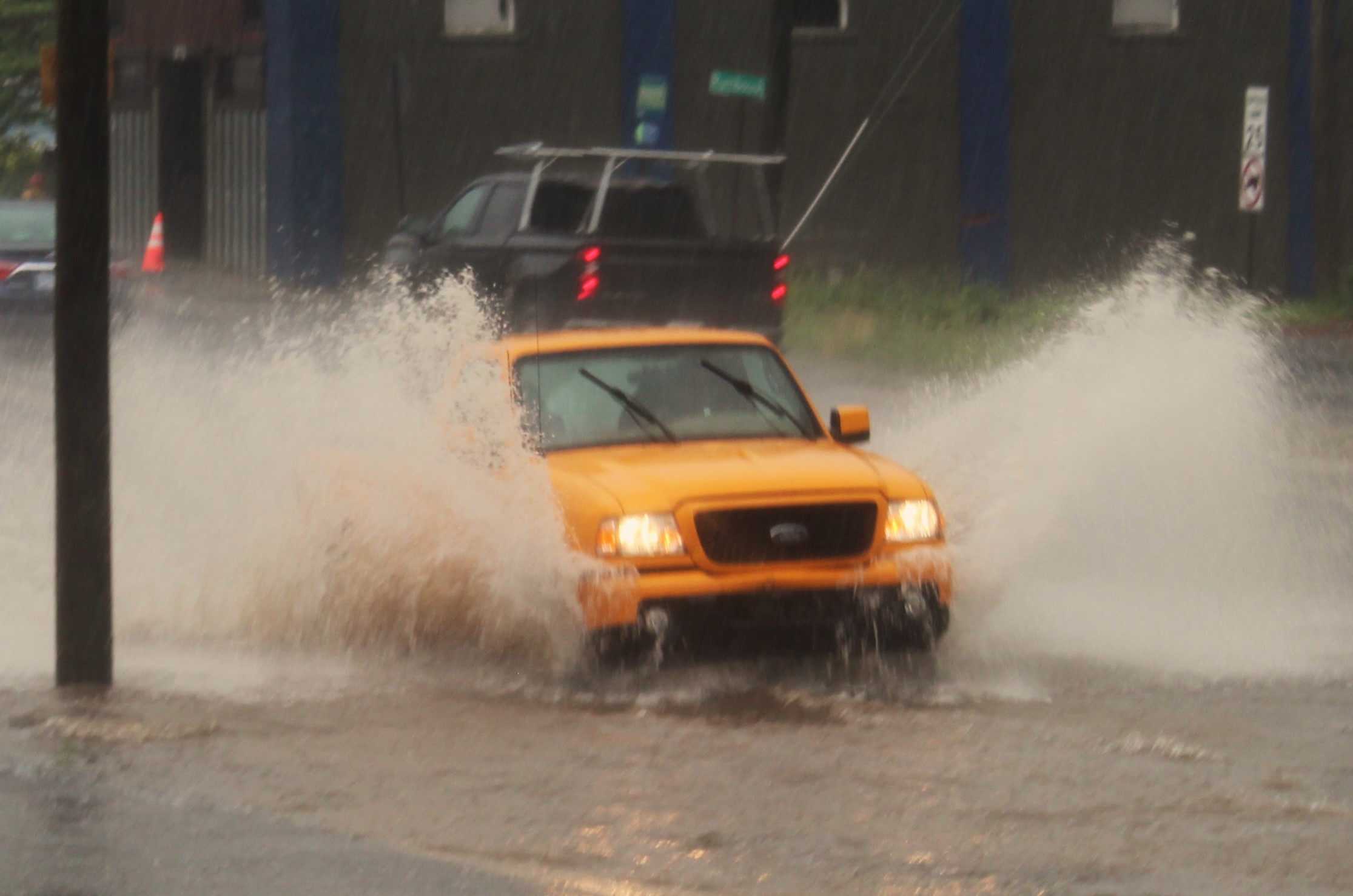 A car splashes through deep water on Smokey Park Highway in Asheville on Saturday, May 4, 2024. The National Weather Service has put the region on a severe thunderstorm watch again through 4 p.m. Wednesday.