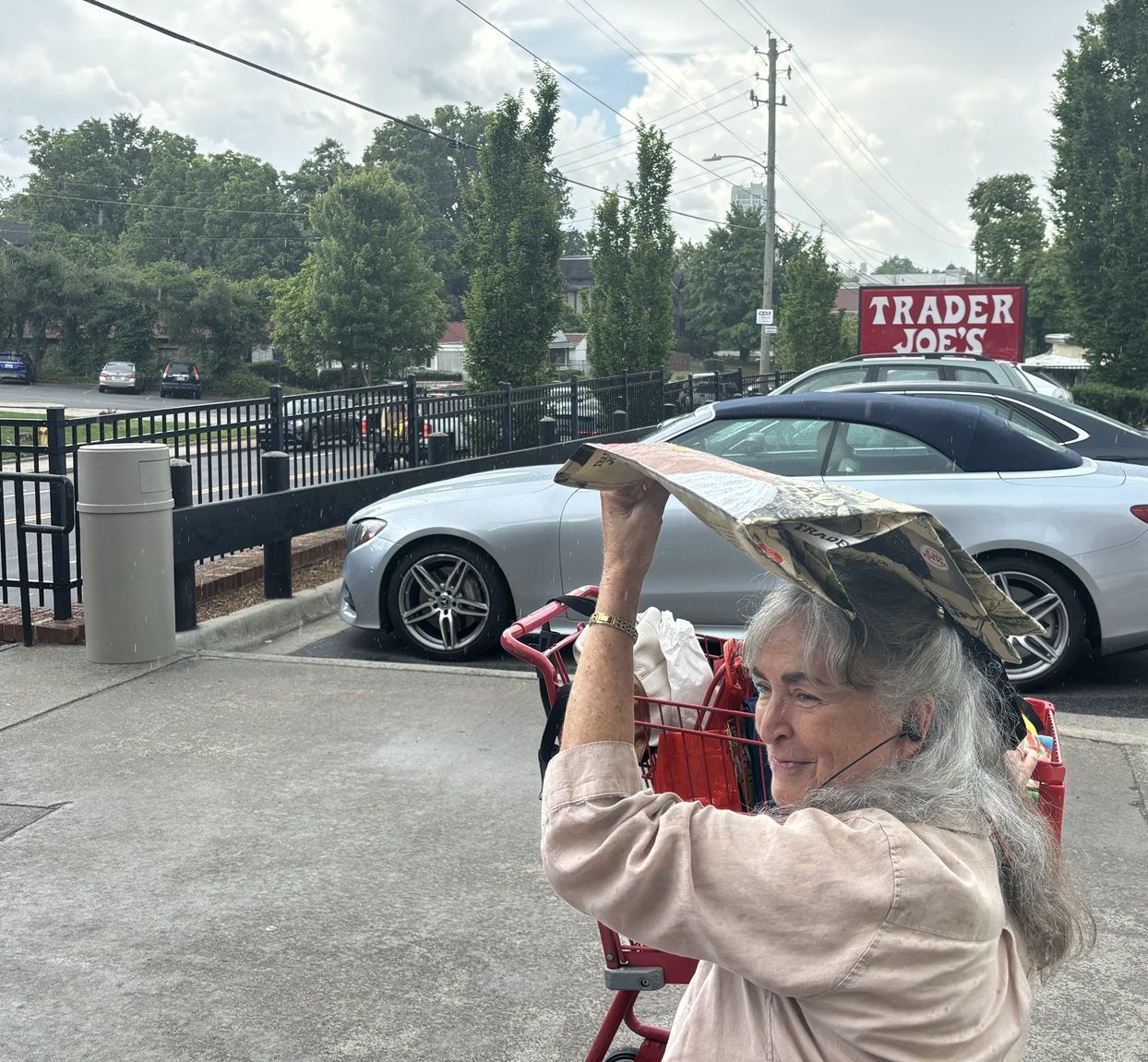 Suzie Hill, of Leicester, keeps out of the rain grocery shopping with a reusable bag.