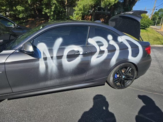 Police say a vandal slashed tires and scrawled graffiti on a vehicle belonging to a member of the committee that has been advocating for a downtown Business Improvement District, or "BID," overnight June 5 to 6, 2024.