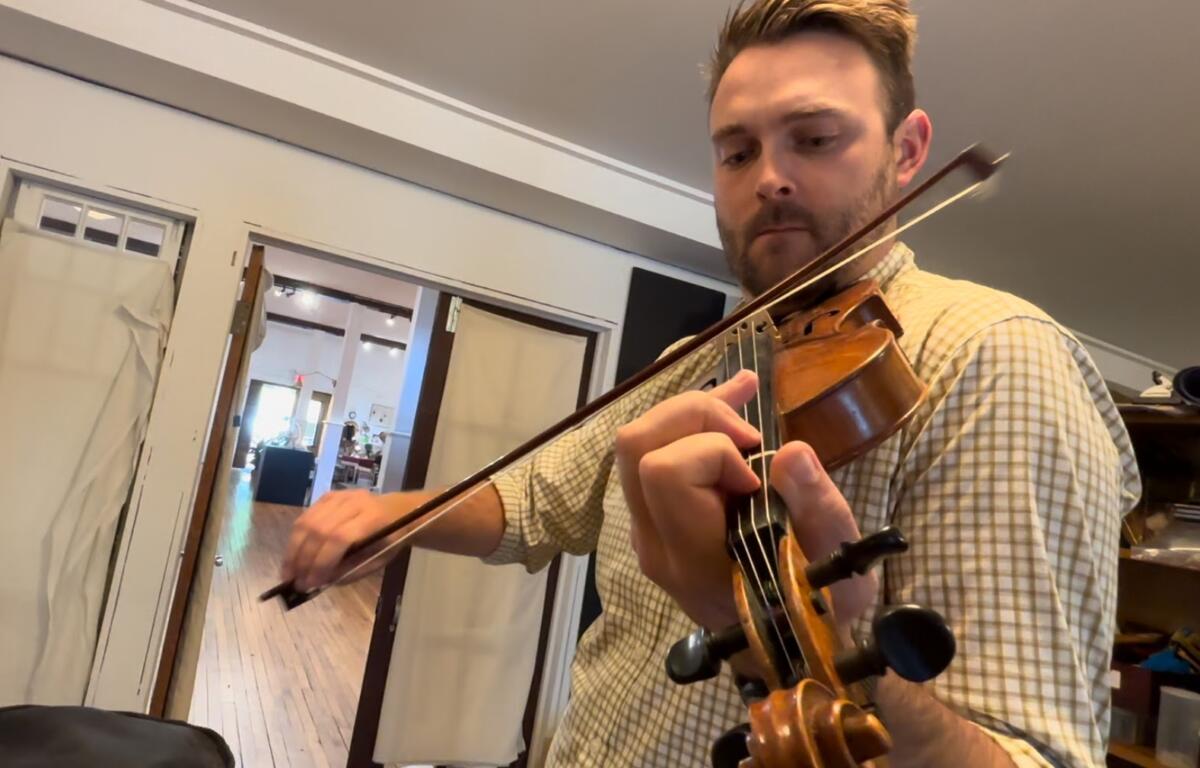 Madison County Arts Council executive director Brandon Johnson plays a version of "Nancy Rowland" by the late Madison County fiddler Tommy Hunter. Johnson builds and repairs violins in his spare time.