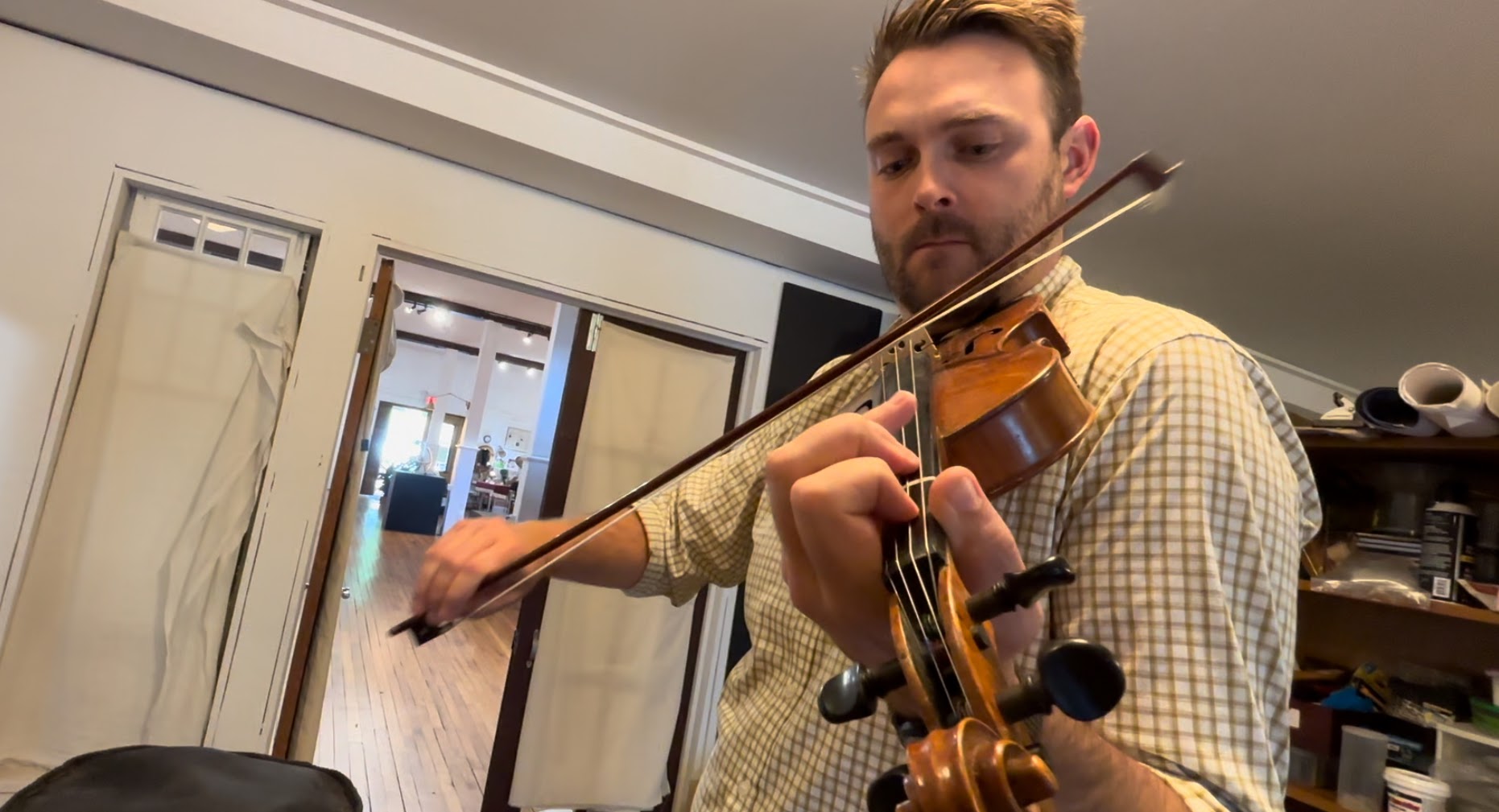Madison County Arts Council executive director Brandon Johnson plays a version of "Nancy Rowland" by the late Madison County fiddler Tommy Hunter. Johnson builds and repairs violins in his spare time.