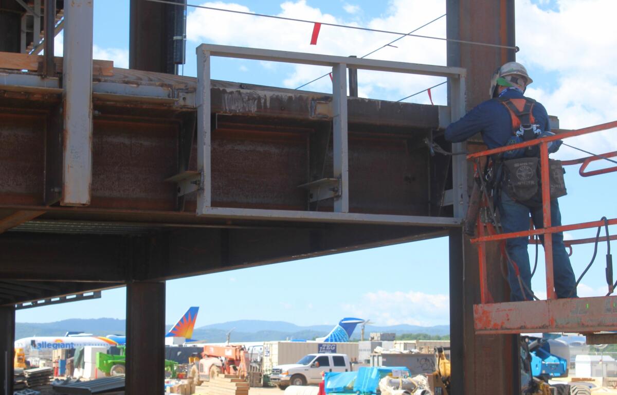 A contractor works on a corner of the new north concourse at Asheville Regional Airport.