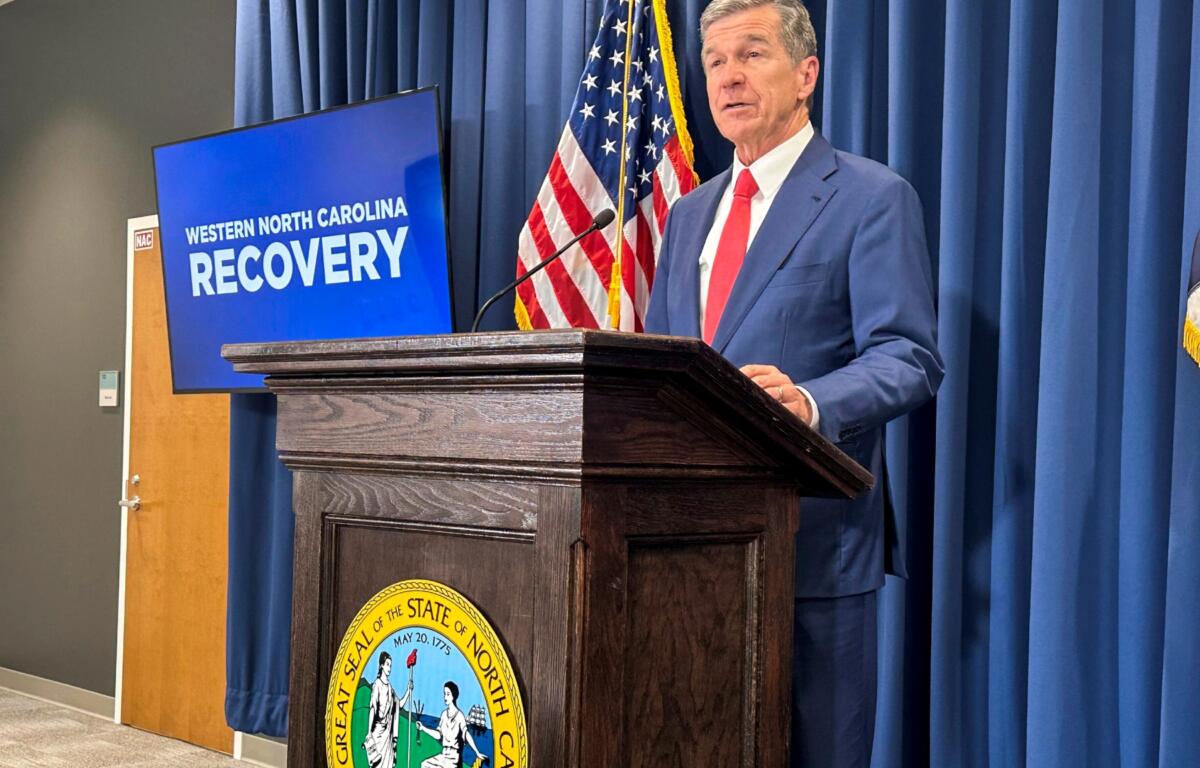 FILE - North Carolina Gov. Roy Cooper unveils a report during a press conference in Raleigh, N.C., Oct. 23, 2024. (AP Photo/Gary D. Robertson, File)