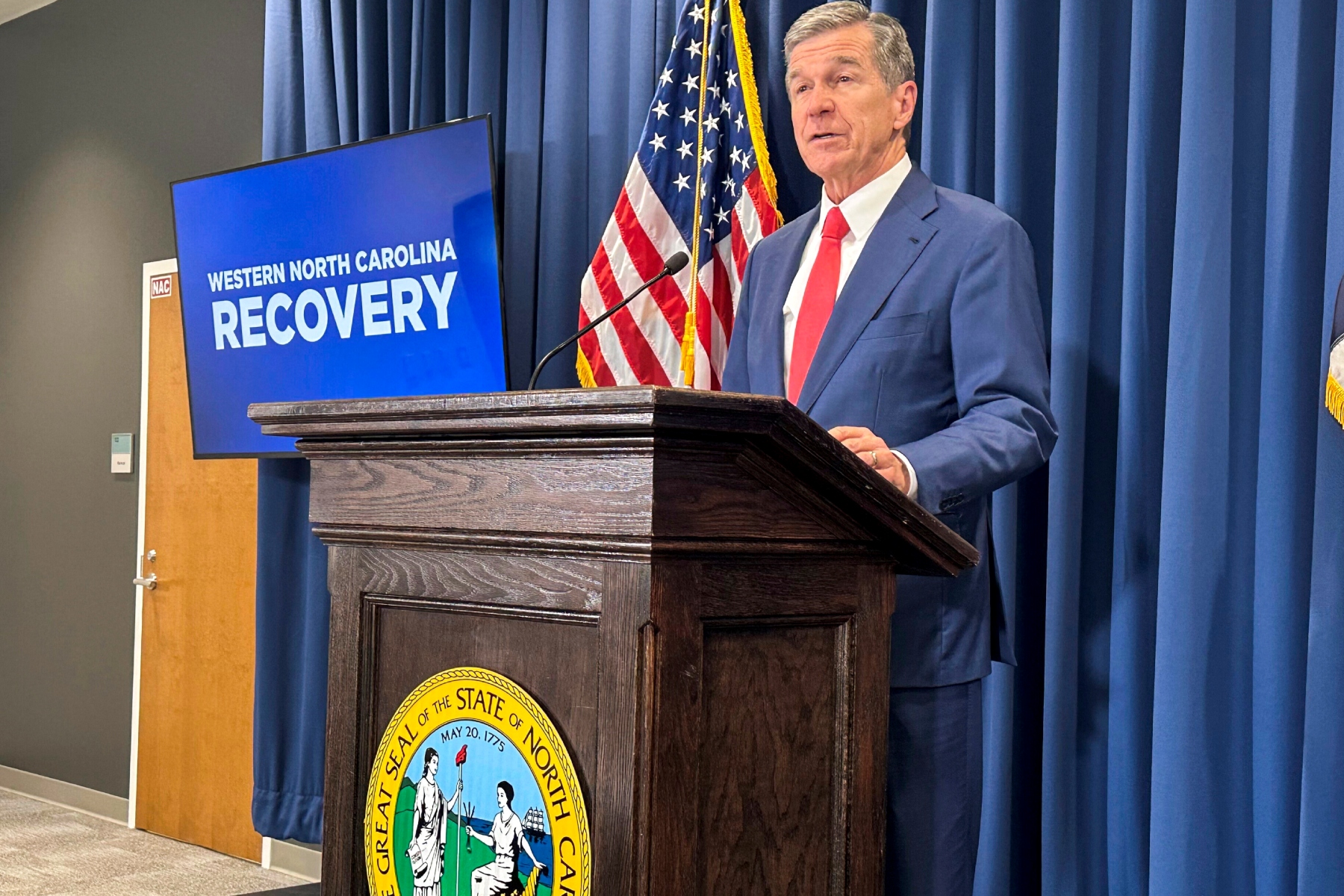 FILE - North Carolina Gov. Roy Cooper unveils a report during a press conference in Raleigh, N.C., Oct. 23, 2024. (AP Photo/Gary D. Robertson, File)