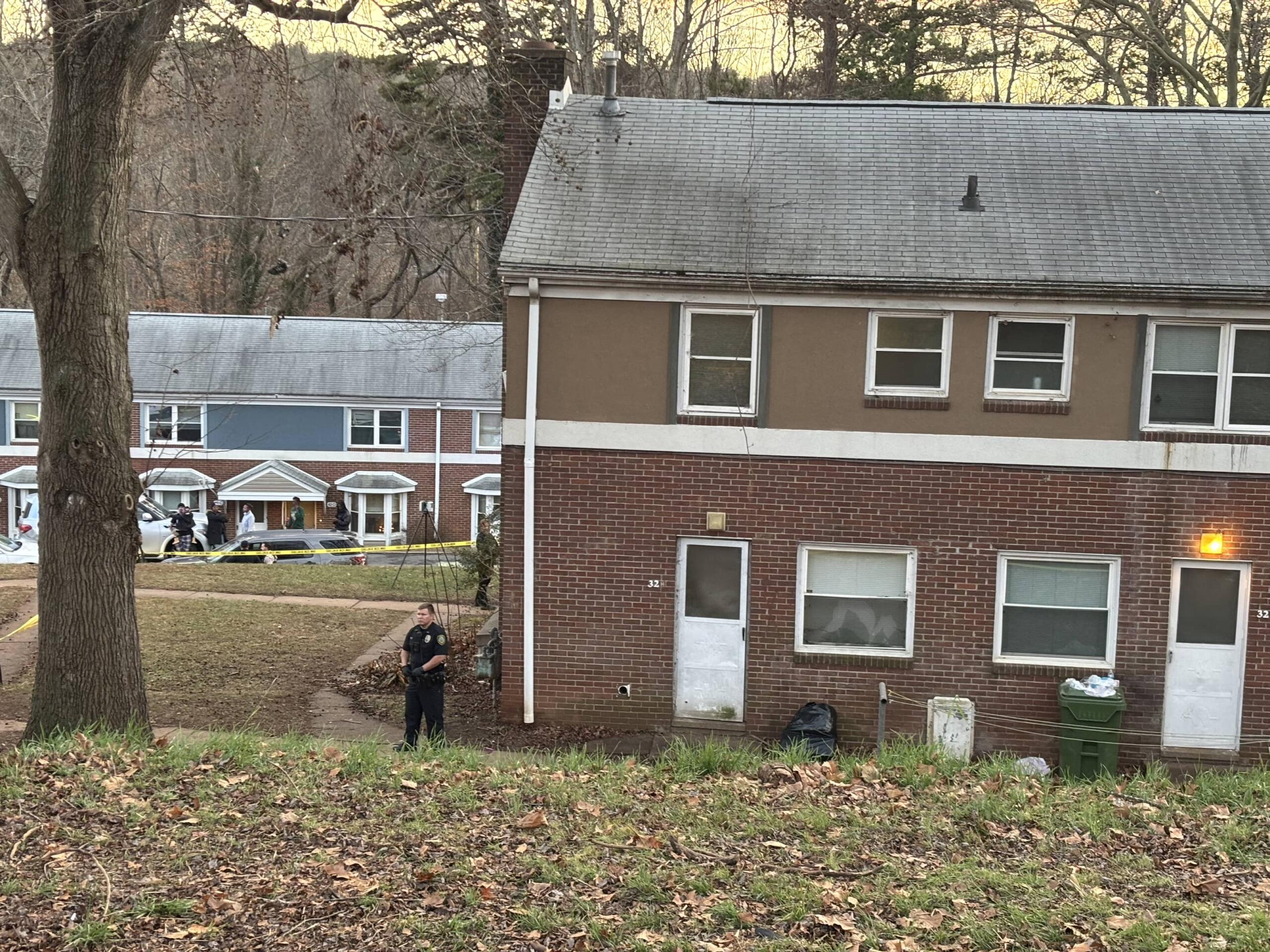 An officer stands outside the apartment complex where a double homicide was committed earlier today, Monday, Dec. 16.