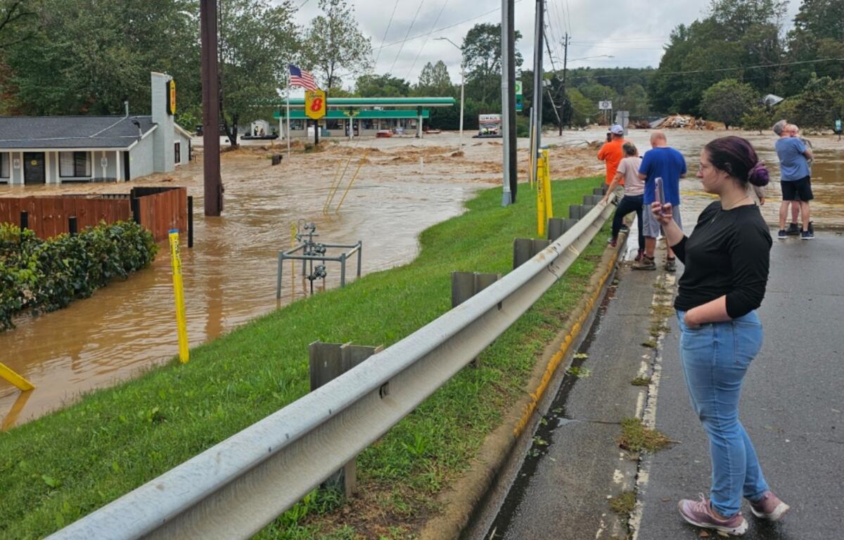 People look at the flooding on U.S. 70 in Swannanoa. The bridge seen here near Interstate 40 exit 55 was damaged in the storm.