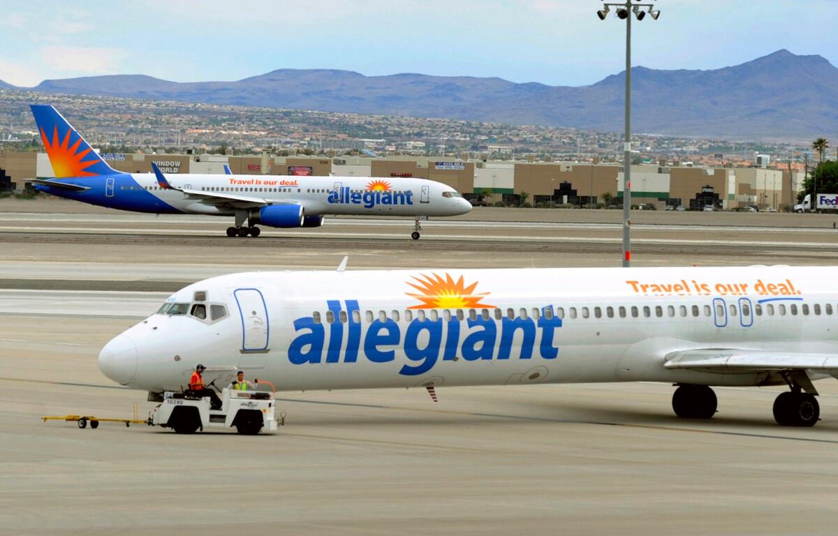 File- In this Thursday, May 9, 2013, file photo, two Allegiant Air jets taxi at McCarran International Airport in Las Vegas. Issues continue to circle overhead for low-fare Allegiant Air as directors gathered in the profitable company's Las Vegas headquarters Thursday, June 18, 2015, for a shareholder meeting. Labor disputes with pilots and flight attendants, equipment problems causing canceled flights and concerns about the CEO's spending on pet projects have plagued the small airline owned and operated by Allegiant Travel Co. (AP Photo/David Becker,File)