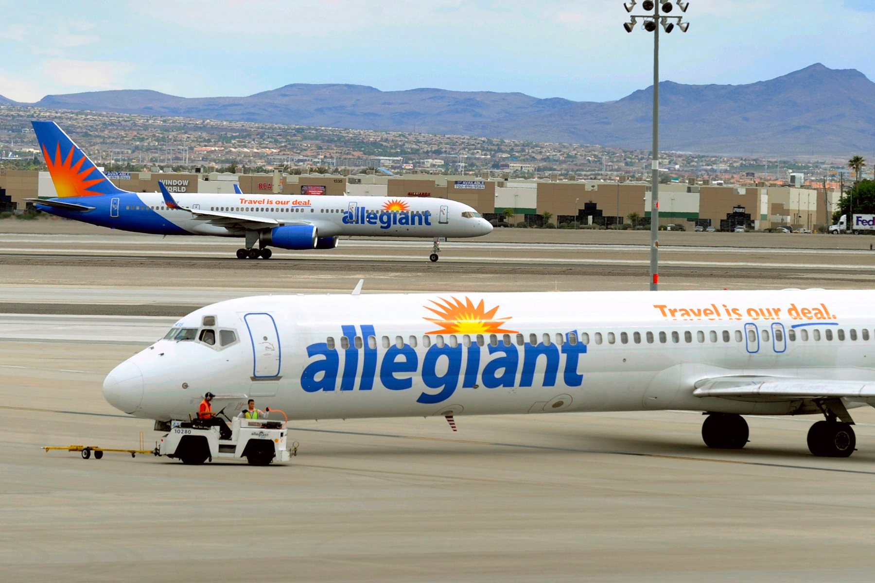 File- In this Thursday, May 9, 2013, file photo, two Allegiant Air jets taxi at McCarran International Airport in Las Vegas. Issues continue to circle overhead for low-fare Allegiant Air as directors gathered in the profitable company's Las Vegas headquarters Thursday, June 18, 2015, for a shareholder meeting. Labor disputes with pilots and flight attendants, equipment problems causing canceled flights and concerns about the CEO's spending on pet projects have plagued the small airline owned and operated by Allegiant Travel Co. (AP Photo/David Becker,File)