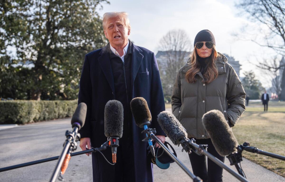 First lady Melania Trump looks on as President Donald Trump speaks with reporters before boarding Marine One on the South Lawn of the White House, Friday, Jan. 24, 2025, in Washington. (AP Photo/Evan Vucci)