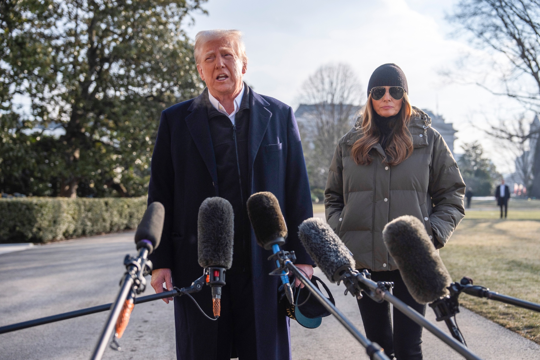 First lady Melania Trump looks on as President Donald Trump speaks with reporters before boarding Marine One on the South Lawn of the White House, Friday, Jan. 24, 2025, in Washington. (AP Photo/Evan Vucci)