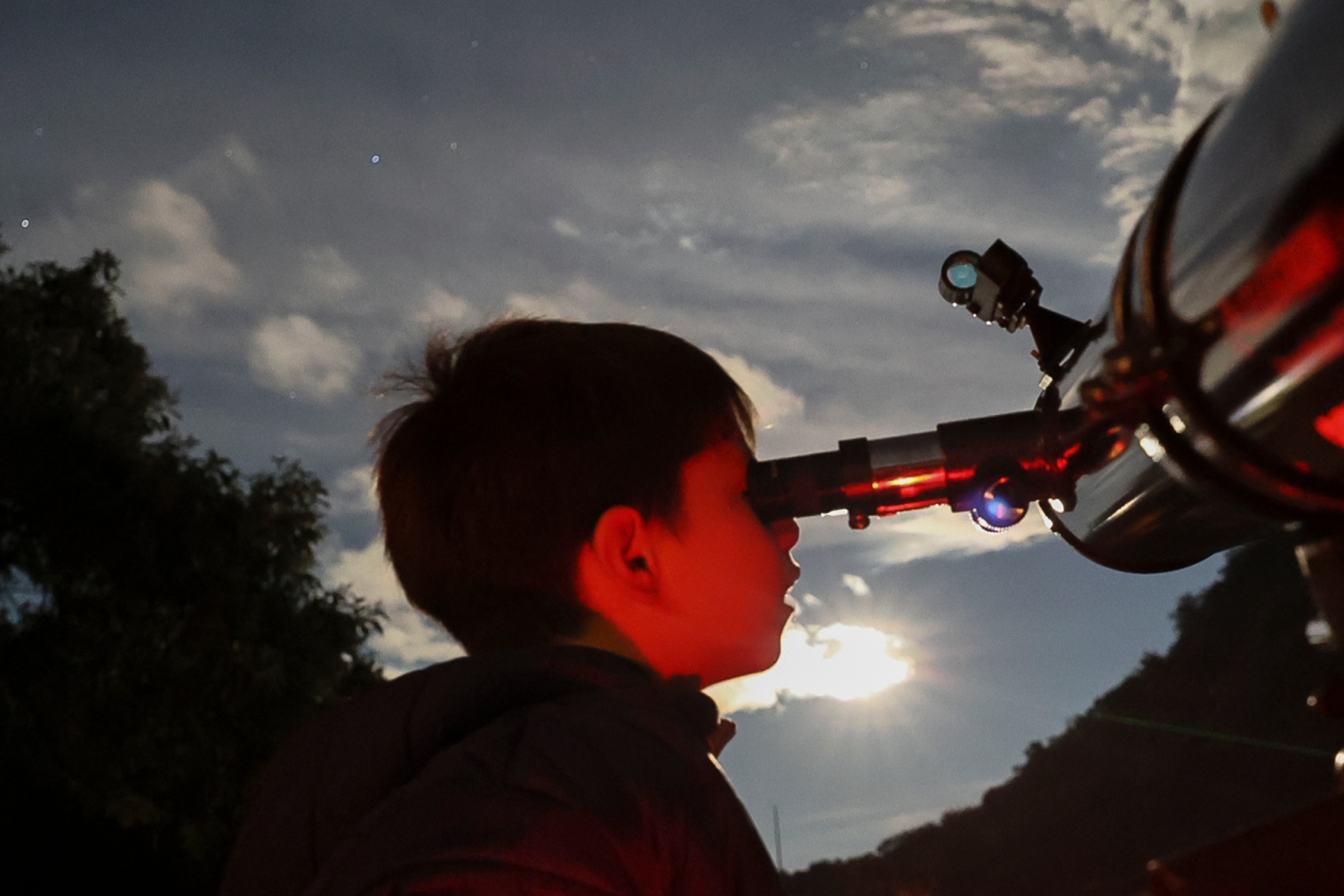 FILE - A youth looks through a telescope during a stargazing and comet-watching gathering at Joya-La Barreta Ecological Park in Queretaro, Mexico, Saturday, Oct. 19, 2024. (AP Photo/Ginnette Riquelme, File)