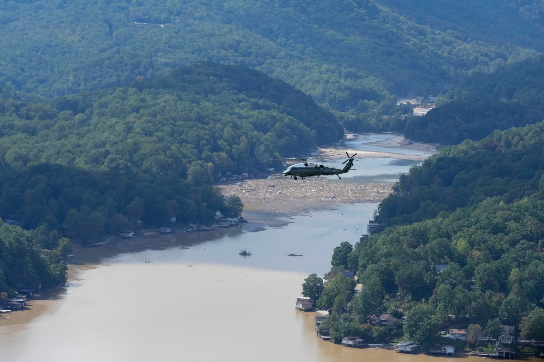 Marine One, with President Joe Biden on board, flies over Lake Lure and around areas impacted by Hurricane Helene near Chimney Rock, N.C., Wednesday, Oct. 2, 2024. (AP Photo/Susan Walsh)