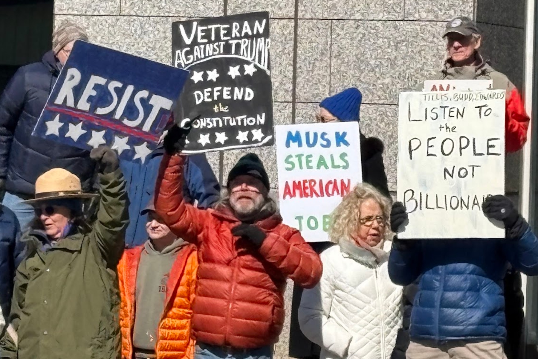 Protesters gathered in front of the Veach-Baley Federal Building at noon Friday, Feb. 21, 2025.