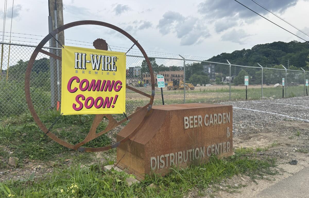 A coming soon sign hung at Hi-Wire Brewing.