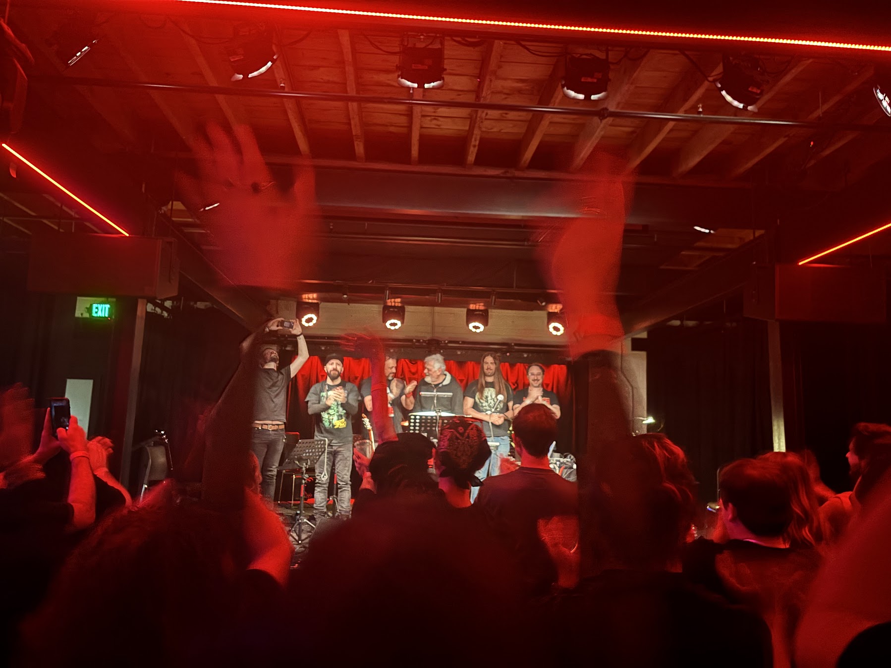 A pair of hands raise above the audience at Eulogy.