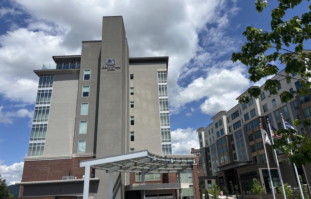 The DoubleTree hotel stands against a cloudy sky in downtown Asheville.