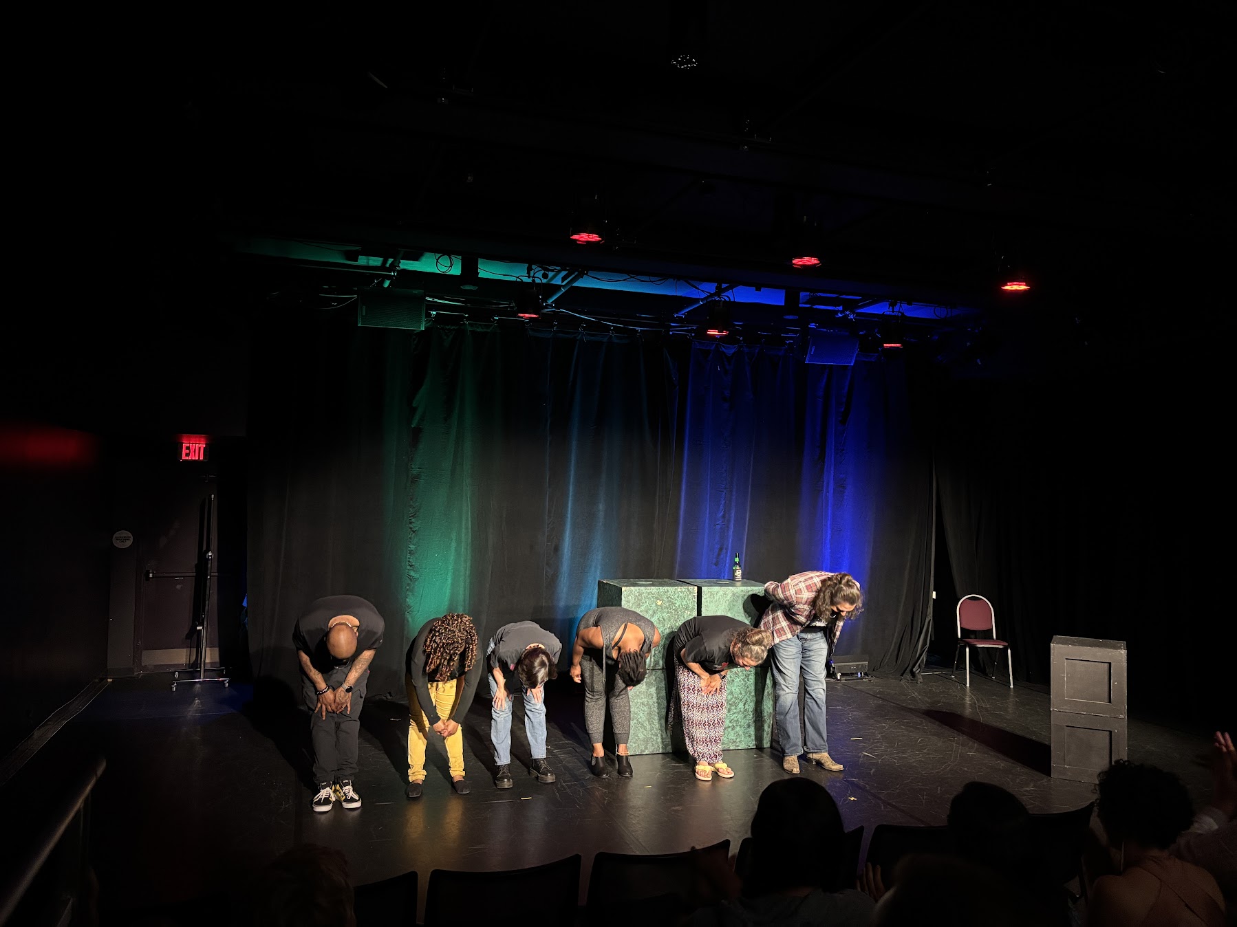 Actors bow onstage after a performance.