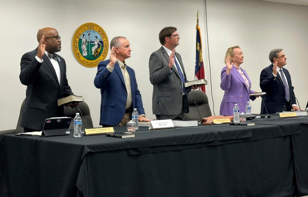 Newly appointed members of the North Carolina State Board of Elections, from left, Jeff Carmon, Francis De Luca, Stacy "Four" Eggers, Siobhan O'Duffy Millen and Bob Rucho, take their oaths of office at the Dobbs Building in Raleigh, N.C., on Wednesday, May 7, 2025 (AP Photo/Gary D. Robertson)