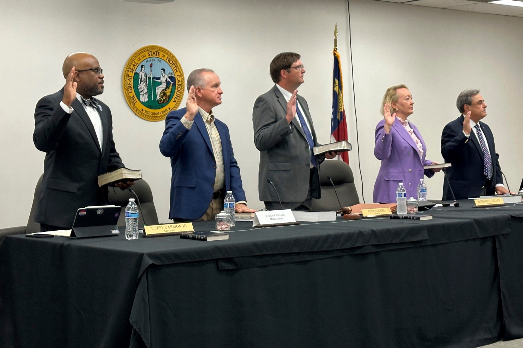 Newly appointed members of the North Carolina State Board of Elections, from left, Jeff Carmon, Francis De Luca, Stacy "Four" Eggers, Siobhan O'Duffy Millen and Bob Rucho, take their oaths of office at the Dobbs Building in Raleigh, N.C., on Wednesday, May 7, 2025 (AP Photo/Gary D. Robertson)