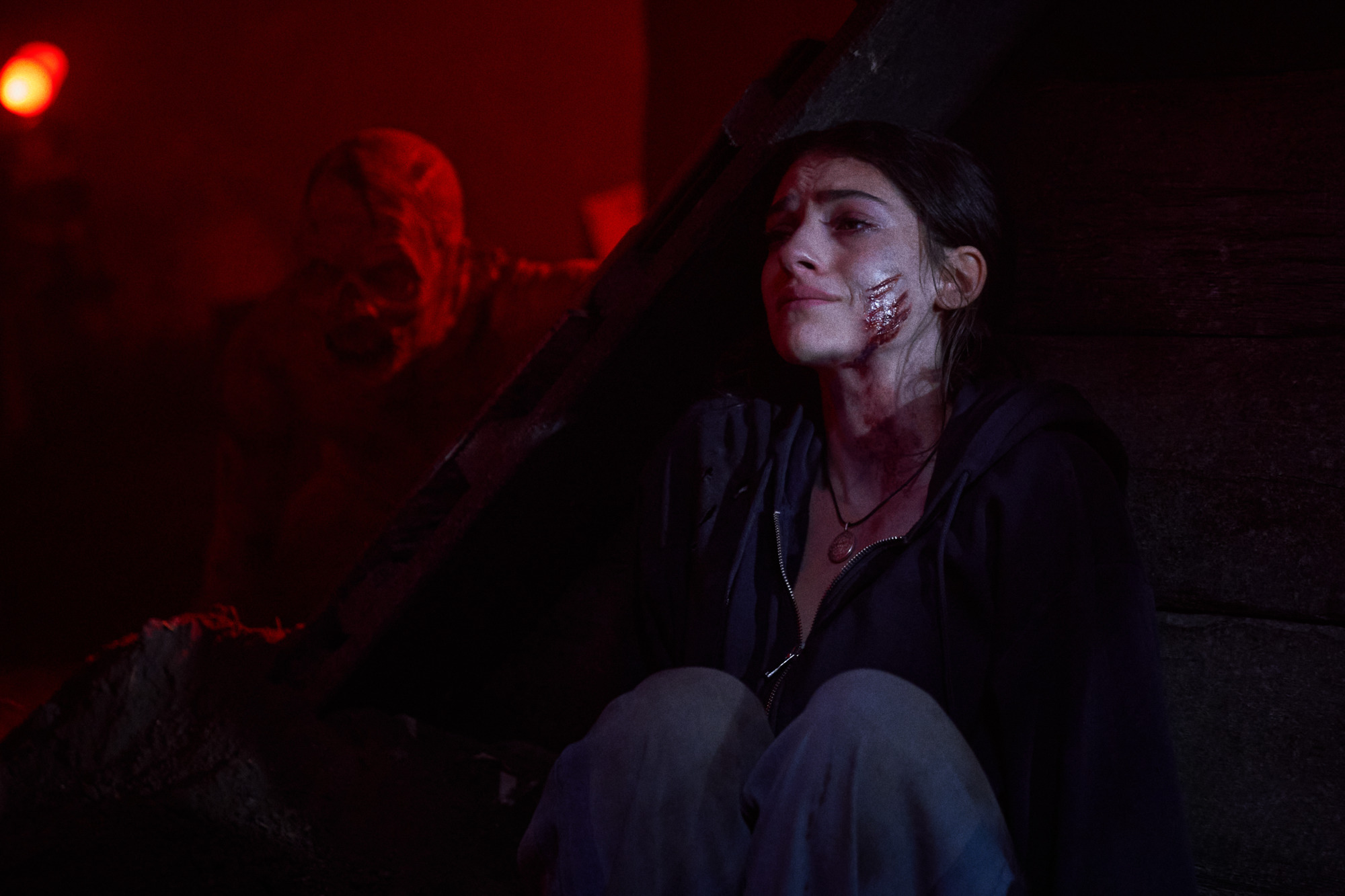 A still of Ella Rubin and a monster from "Until Dawn."