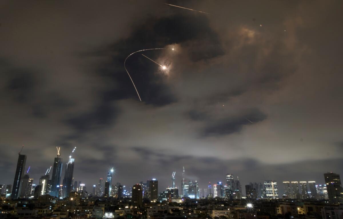 Israeli air defense system fires to intercept missiles during an Iranian attack over Tel Aviv, Israel, Saturday, June 21, 2025. (AP Photo/Leo Correa)