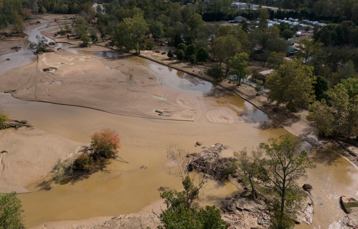 Water is seen outside the banks of the Swannanoa river in the aftermath of Hurricane Helene, Tuesday, Oct. 1, 2024, in Swannanoa, N.C. (AP Photo/Mike Stewart)