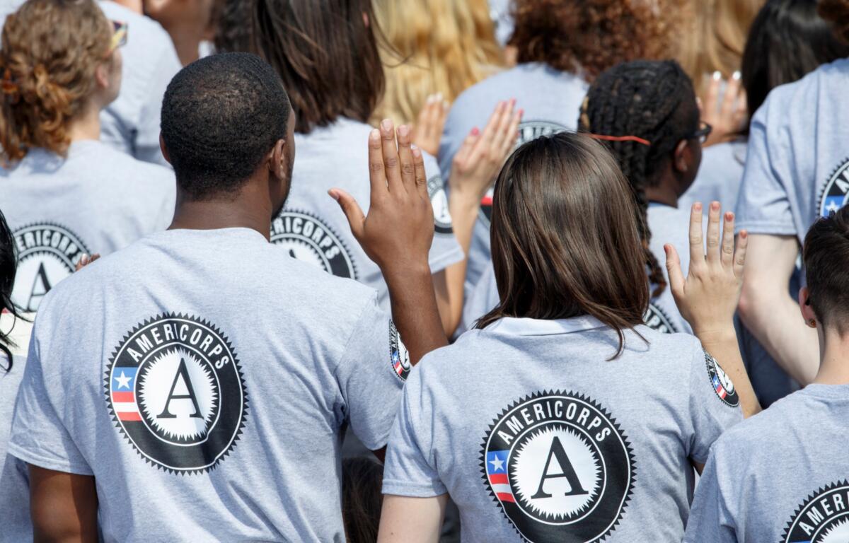 FILE - As President Barack Obama and former President Bill Clinton mark the 20th anniversary of the AmeriCorps national service program, hundreds of new volunteers are sworn in for duty at a ceremony, Friday, Sept. 12, 2014, on the South Lawn of the White House in Washington. (AP Photo/J. Scott Applewhite, file)