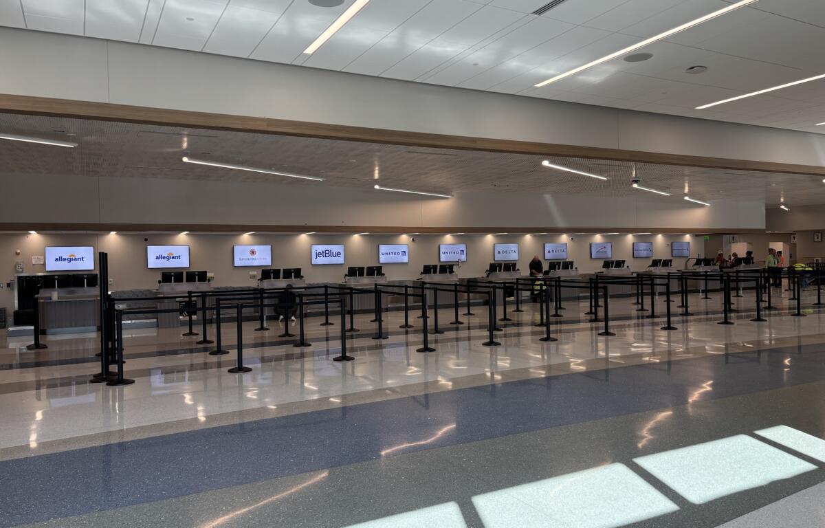 New airport ticket counters in a bright, airy room.