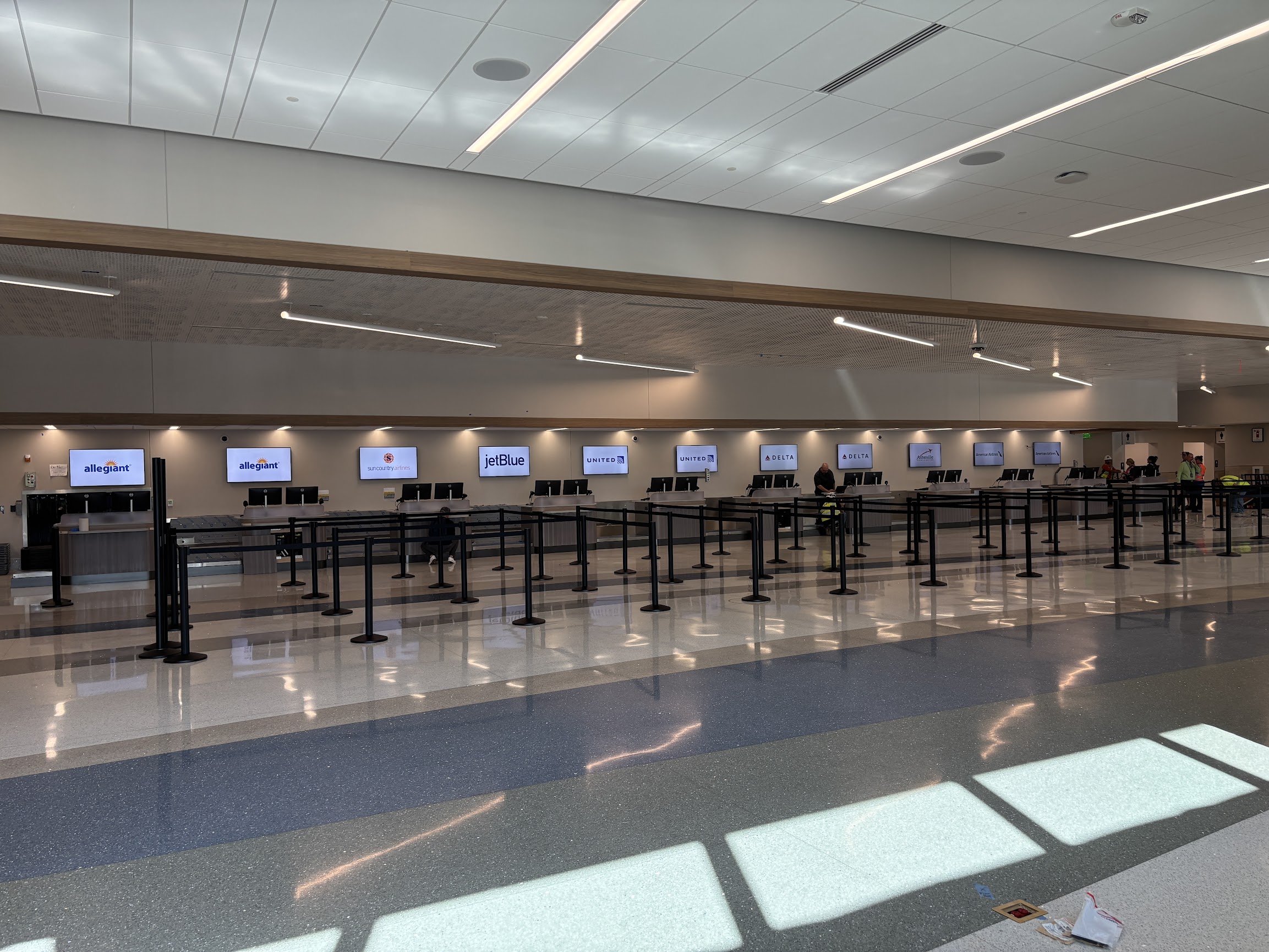 New airport ticket counters in a bright, airy room.