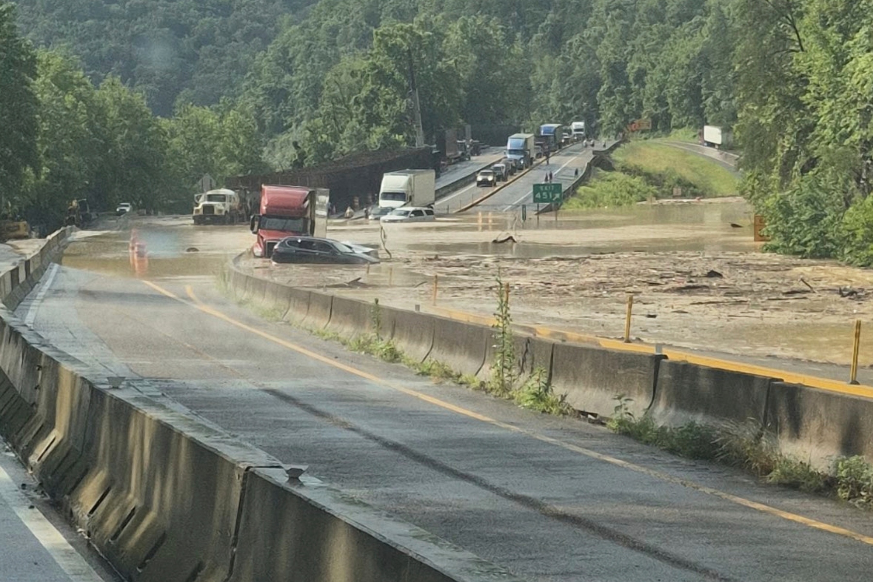 This photo provided by Tennessee Department of Transportation shows Interstate 40 remains closed near the Tennessee-North Carolina state line due to flooding and rockslide on Wednesday, June 18, 2025. (Tennessee Department of Transportation via AP)