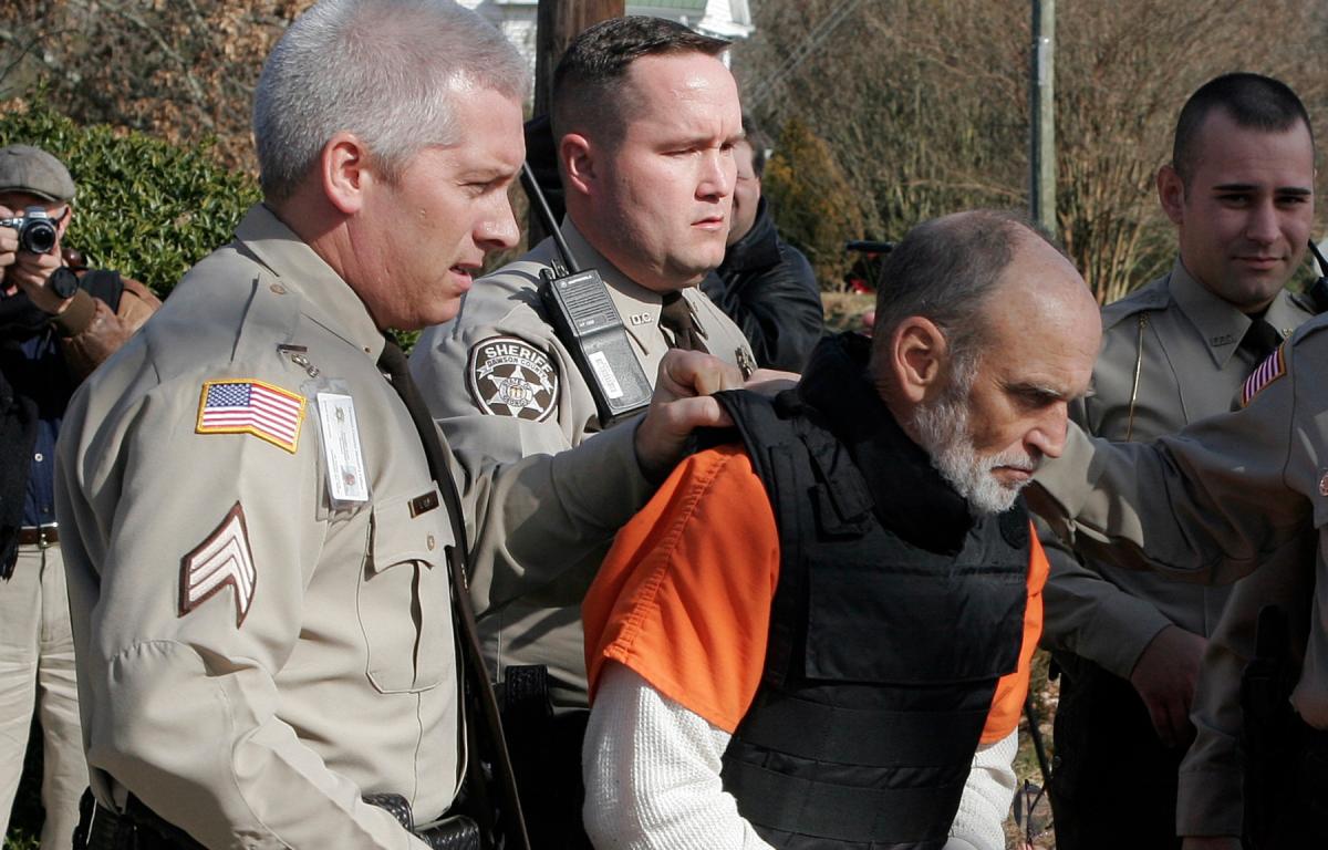 Gary Michael Hilton is escorted to a police car after pleading guilty to murdering hiker Meredith Emerson Thursday, Jan. 31, 2008 in Dawsonville, Ga. Emerson was kidnapped while hiking in the north Georgia mountains on New Year's Day 2008. (AP Photo/John Bazemore)