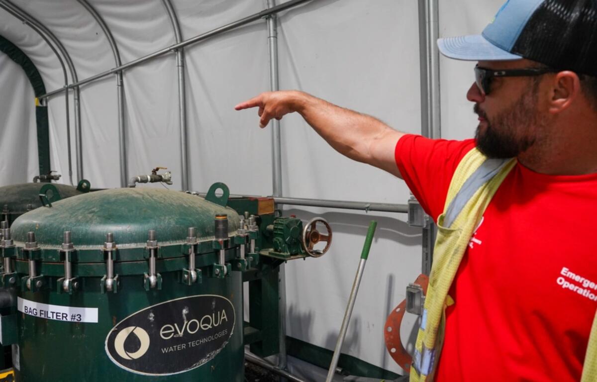 Jeff Wood, USACE quality assurance representative for the Bee Tree Reservoir Turbidity Reduction System, discusses how the bag filter system is the last stop before water is sent to the city water treatment plant in Asheville, North Carolina. (Photo Credit: Michael Maddox)
