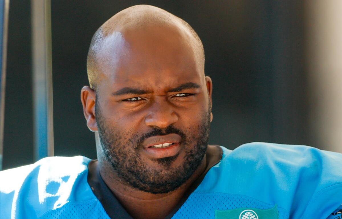 FILE - Carolina Panthers tackle Taylor Moton rides in a cart to the team's NFL football training camp in Charlotte, N.C., Saturday, July 26, 2025. (AP Photo/Nell Redmond, FIle)