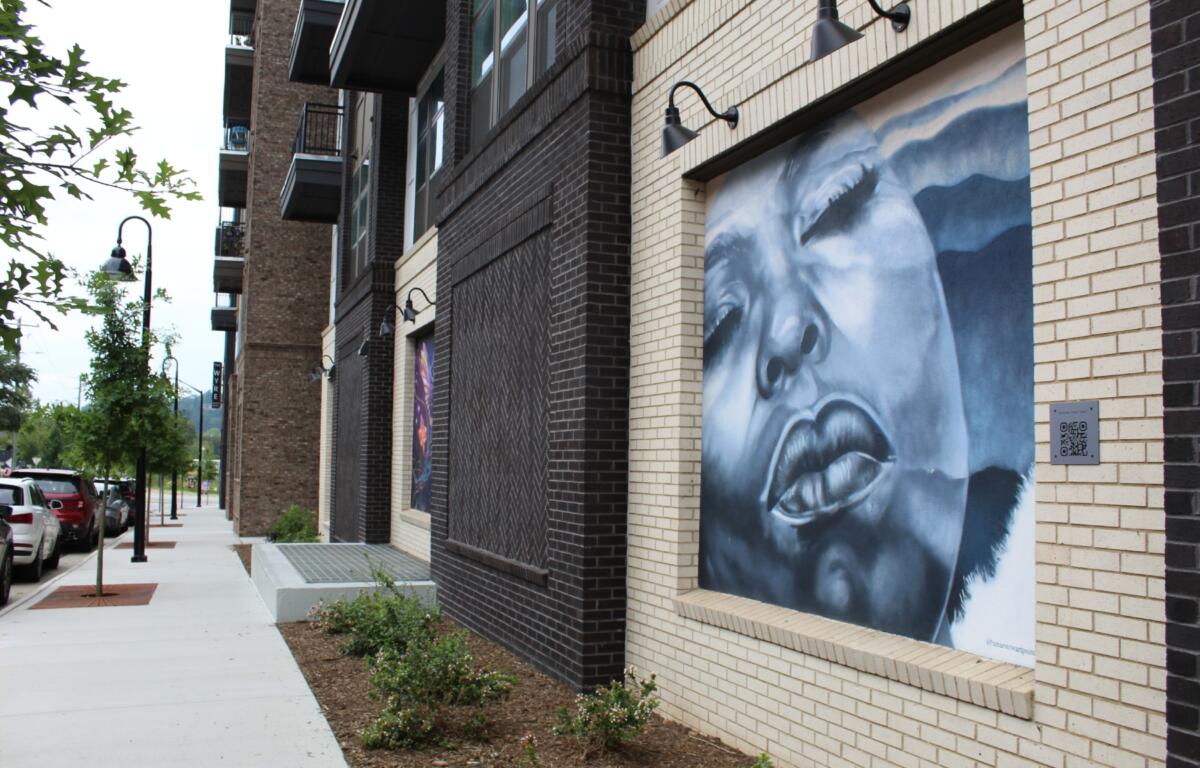 A new mural that anchors The Wyre covers eight panels and features the work of three artists -- Victor Palenque, known as Ishmael, Asheville-based painter Amar Stewart and Miami-born artist Oscar Montes.