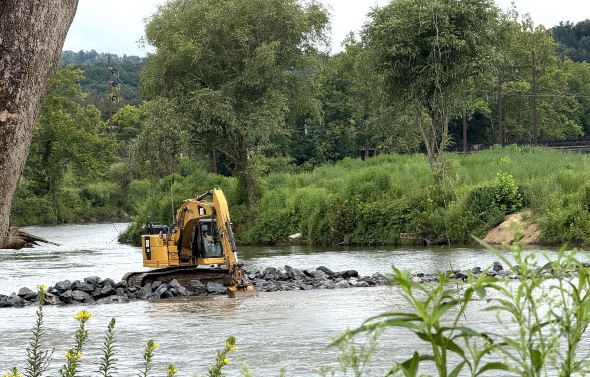 Temporary cofferdams made of rock and water bladders will extend from the riverbank into the center of the French Broad River during a multi-year project to replace the Metropolitan Sewerage District’s Carrier Bridge Pump Station.