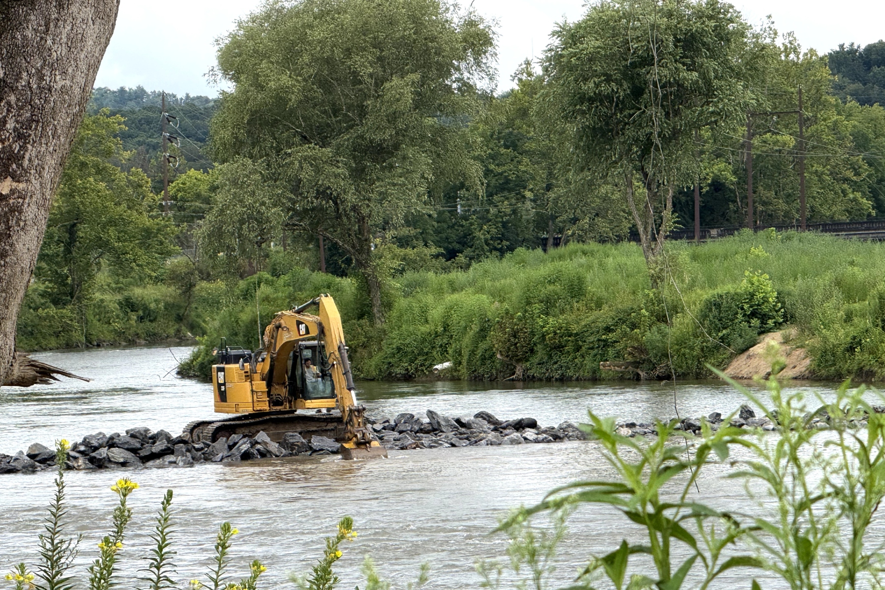 Temporary cofferdams made of rock and water bladders will extend from the riverbank into the center of the French Broad River during a multi-year project to replace the Metropolitan Sewerage District’s Carrier Bridge Pump Station.