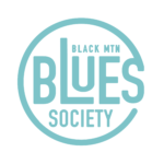 Circular turquoise logo featuring large stylized text that reads 'BLUES' with 'BLACK MTN' above and 'SOCIETY' below; appears to be a brand logo.