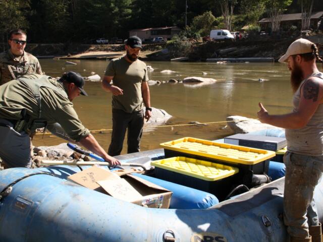 Connecticut Army National Guard members, accompanied by civilian volunteers, deliver supplies to residents in the aftermath of Hurricane Helene on Tuesday, Oct. 8, 2024, in Burnsville, N.C. (AP Photo/Makiya Seminera)