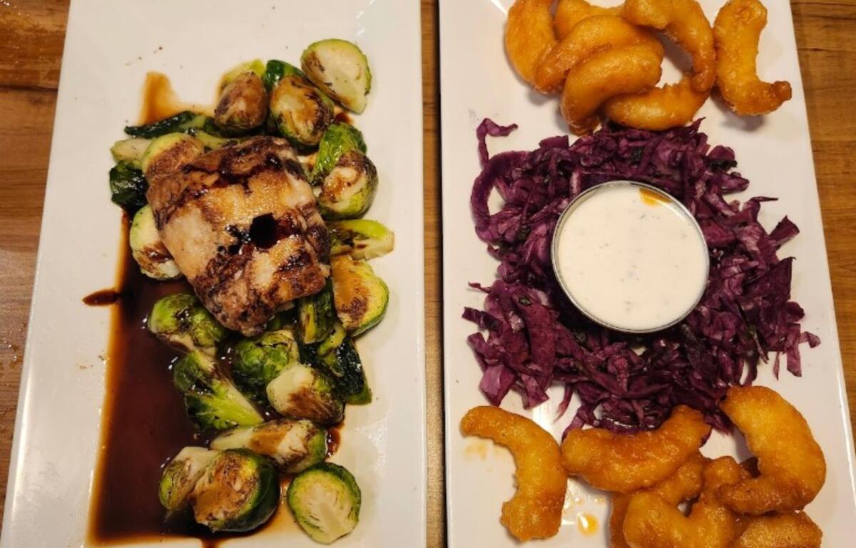 Buffalo shrimp with red cabbage slaw and pork belly over Brussel sprouts with maple glaze.
