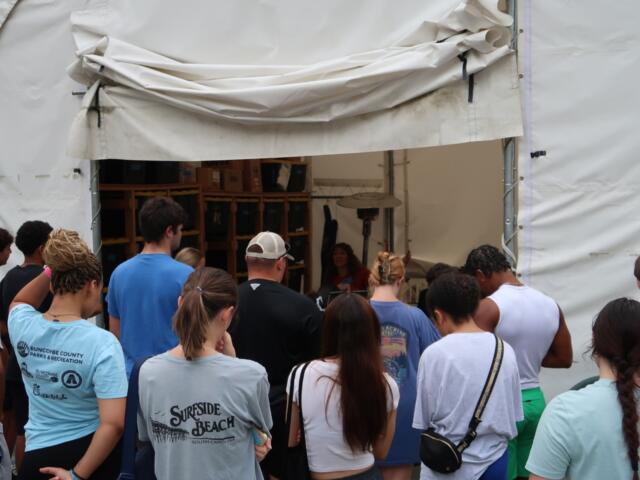 A group of Marshall Relief Alliance volunteers waits for instructions during a workday in August.