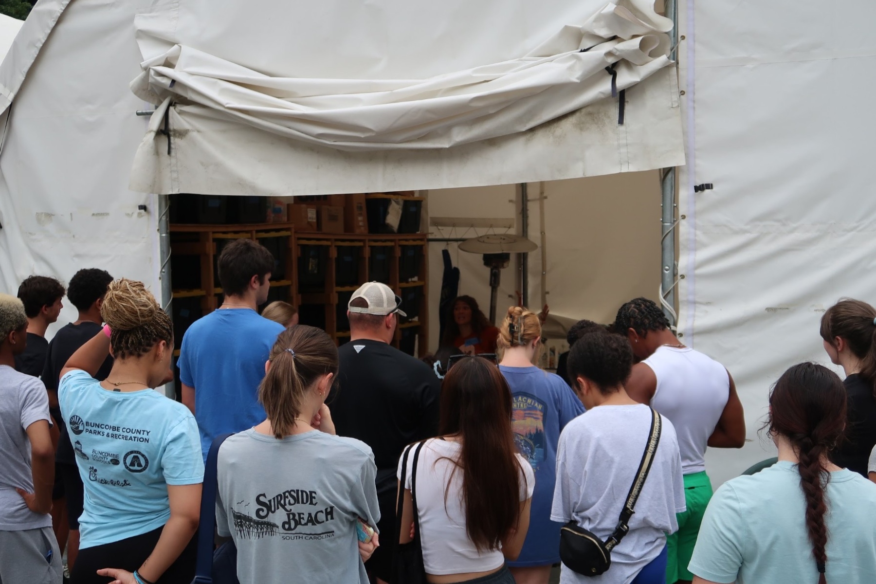 A group of Marshall Relief Alliance volunteers waits for instructions during a workday in August.