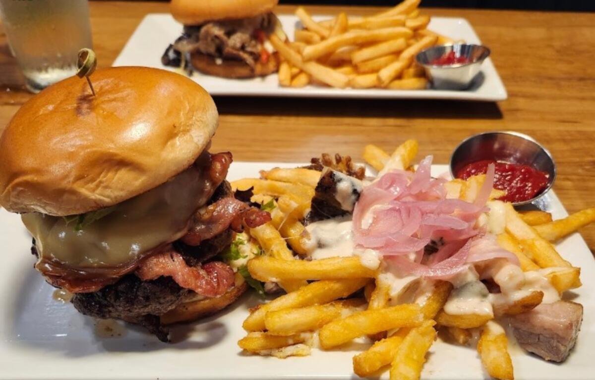 The North Asheville burger, a side of poutine (gravy and brisket over French fries with pickled onion) and a ribeye sandwich, which contained shaved ribeye, sautéed peppers, mushrooms, onions, white cheddar and horseradish crema on a brioche bun.