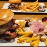 The North Asheville burger, a side of poutine (gravy and brisket over French fries with pickled onion) and a ribeye sandwich, which contained shaved ribeye, sautéed peppers, mushrooms, onions, white cheddar and horseradish crema on a brioche bun.