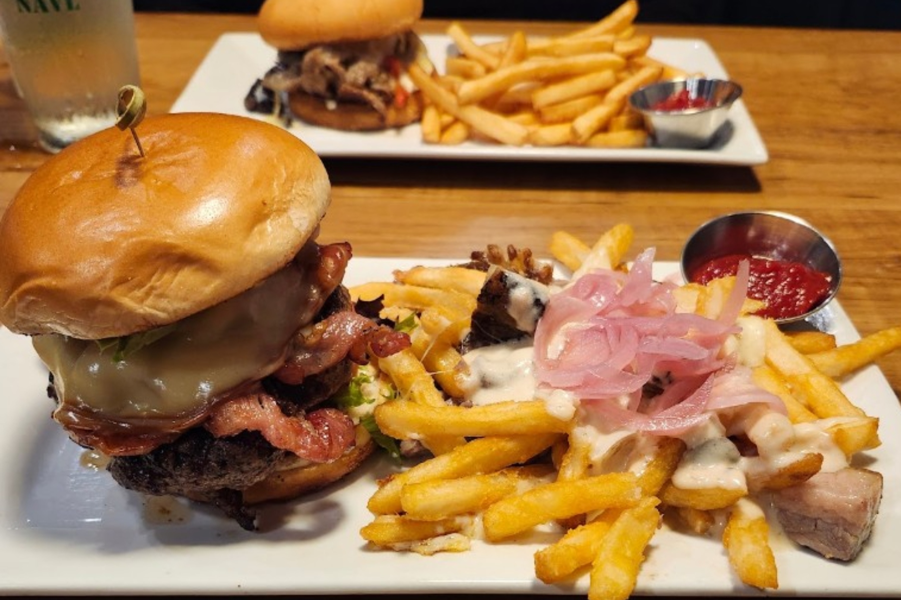 The North Asheville burger, a side of poutine (gravy and brisket over French fries with pickled onion) and a ribeye sandwich, which contained shaved ribeye, sautéed peppers, mushrooms, onions, white cheddar and horseradish crema on a brioche bun.